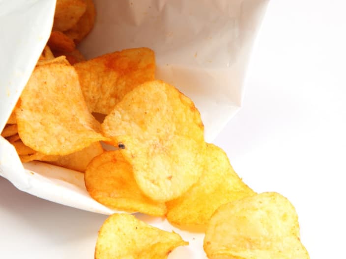 The bags of potato chips are designed to slow down oxidation and to keep the chips fresh
