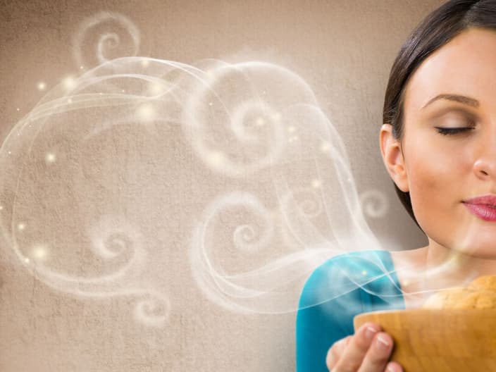 Beautiful woman holding hot fresh smelling oat cookies with closed eyes and relaxing. Retro stylized enjoying food poster with place for your text on grunge background