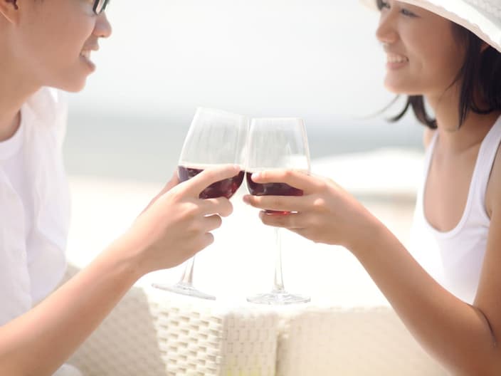 dopamine in alcohol - Young couple clinking glasses