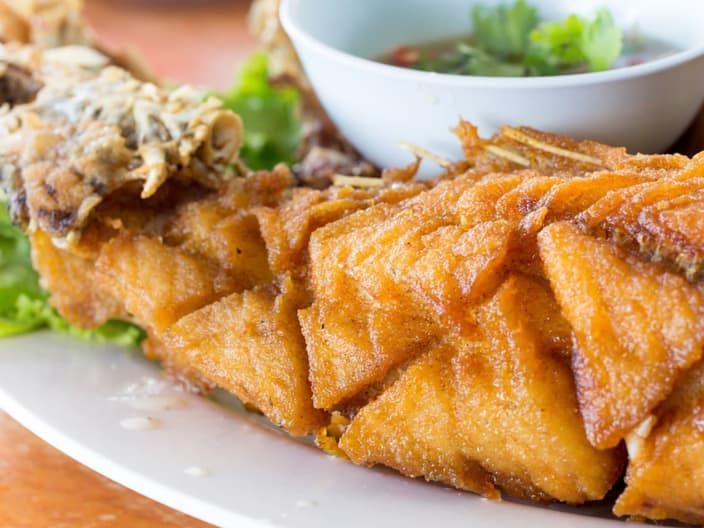 score marks visible on fish - Fried seafish with Thai style sauce