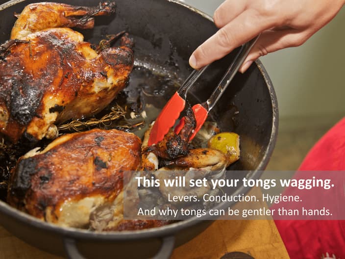 Tongs picking up chicken