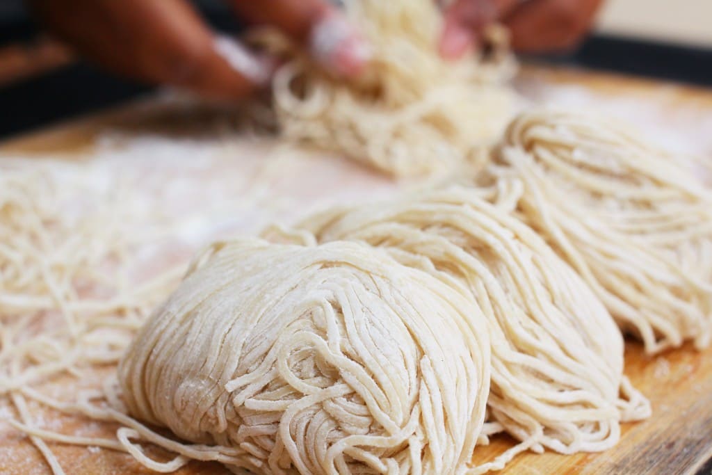 Chef making egg noodles
