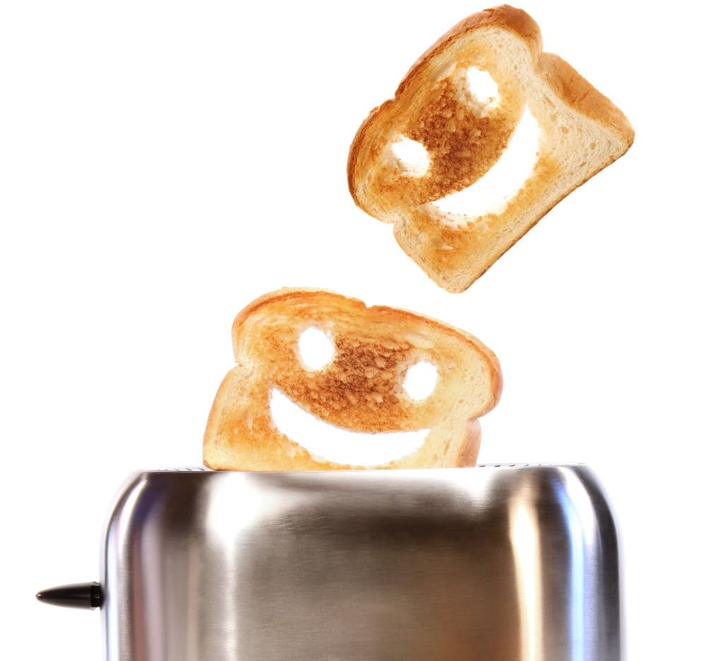 Toasted bread with toaster on white background