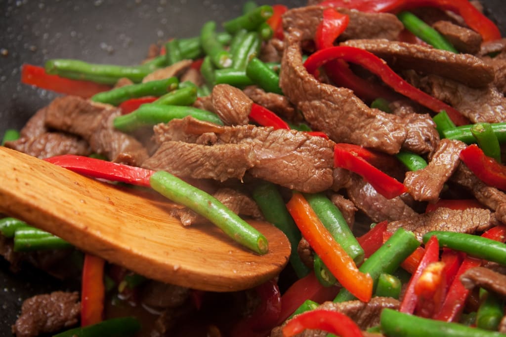 wok hei - Delicious beef, capsicum, and bean stirfry cooking in wok