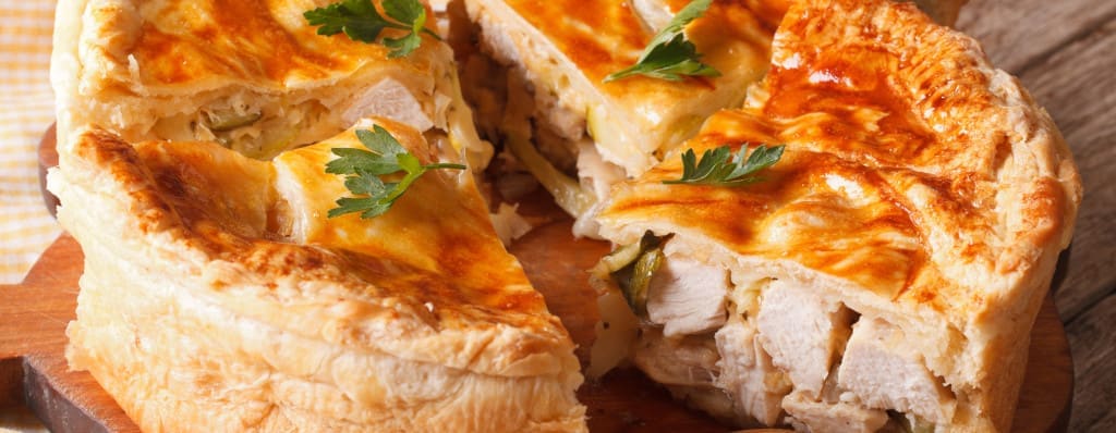 Chopped chicken pie close-up on the table. 