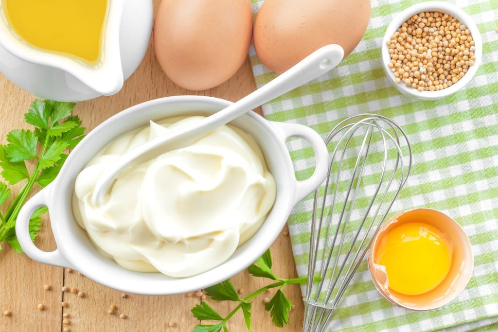 Mayonnaise with eggs, oil, and whisk