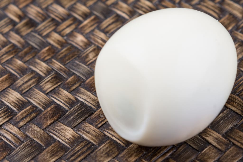 peeled egg showing air bubble or crater