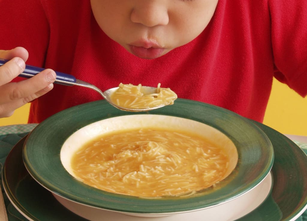 blowing on broth/soup to cool it down