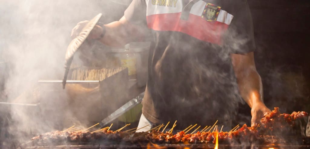 Man selling satay grilled meat