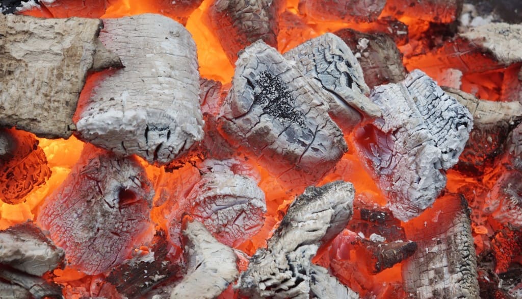 Glowing Coals in BBQ Pit. Background or Texture for text or image