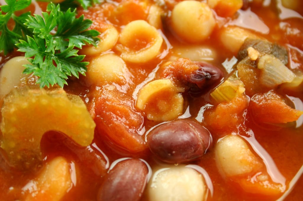 Close up of delicious freshly made Italian minestrone soup with parsley and beans