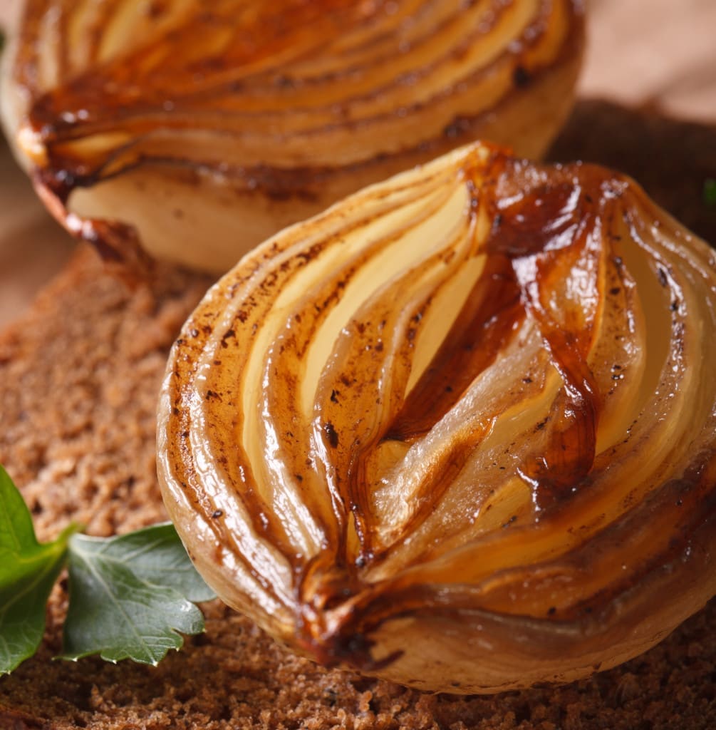 caramelization - caramelized onions, parsley and bread macro on an old table, vertical, rustic style