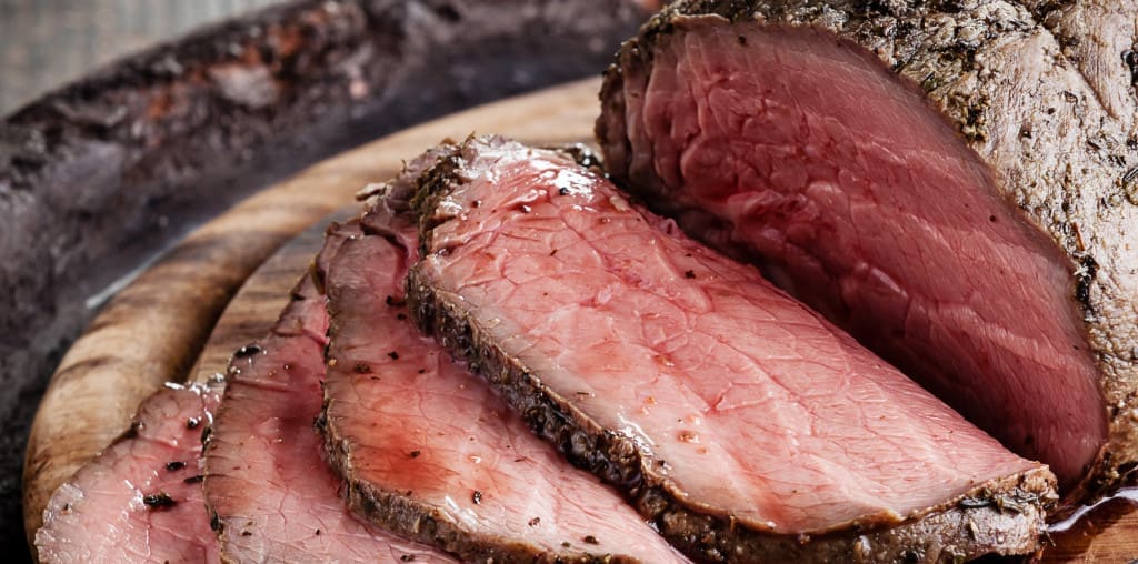 Roast beef on cutting board and knife