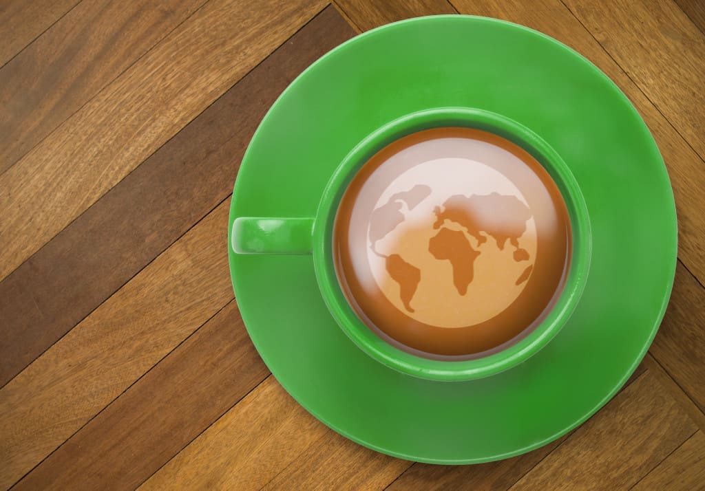 Earth against wooden surface with planks in a cup of tea