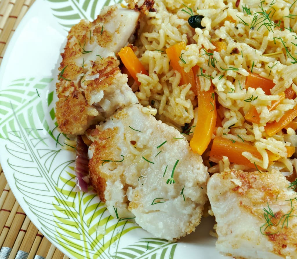 Azerbajian balık plov - a golden burnt rice crust features prominently in this fish pilaf dish.