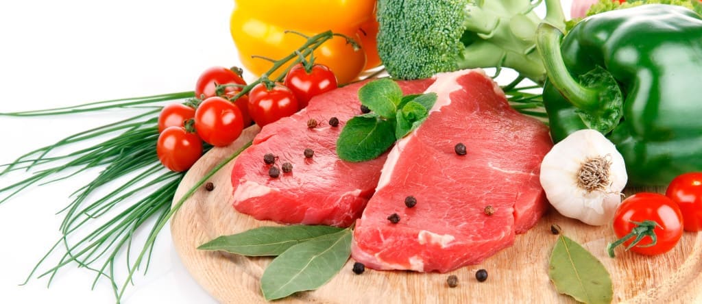 raw meat, spices, with fresh vegetables isolated on white background