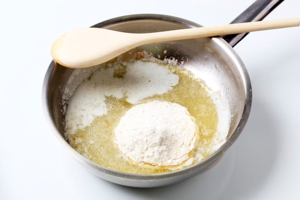 making roux - Wheat flour and heated butter in a saucepan