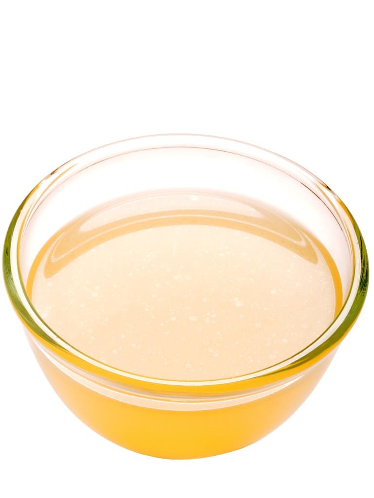 close up of a bowl of chicken stock isolated