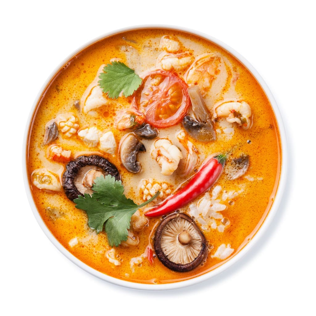 Spicy Thai soup Tom Yam with Coconut milk, Chili pepper and Seafood