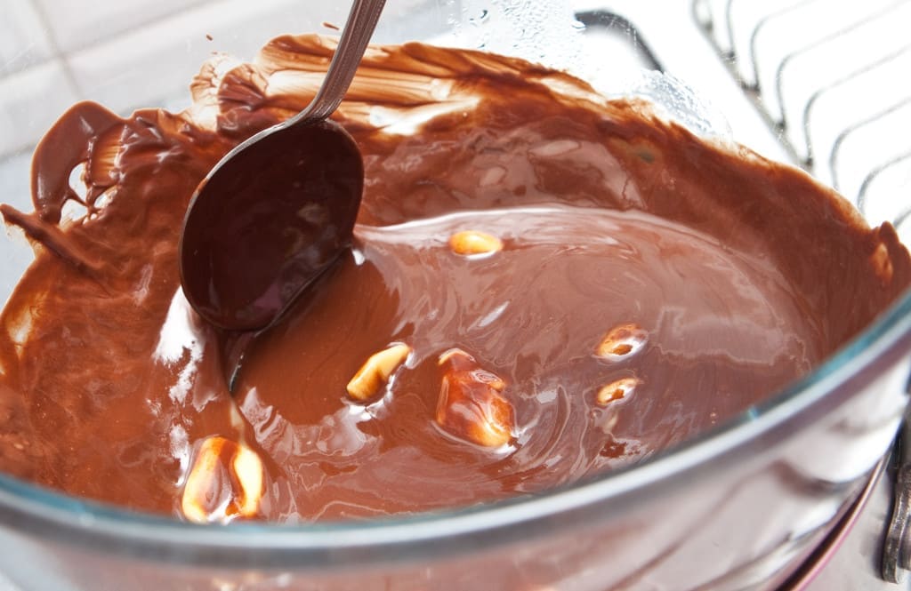 Melting chocolate in a water bath/bain marie ( in a bowl above boiling water ).