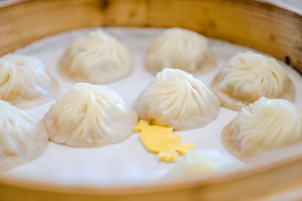 steamed dumpling for chinese food name is Xiao Long Bao in bamboo steamer