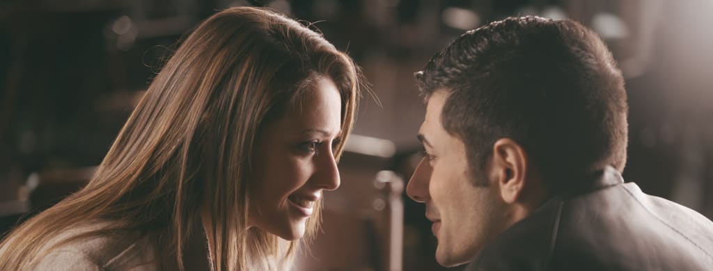 The white of the eye evolved so that we can see how much we trust or like someone - Romantic couple at the bar staring at each other's eyes