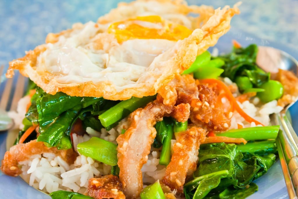 Thai food, kana moo krob.(fried kale mixed crispy pork and egg o