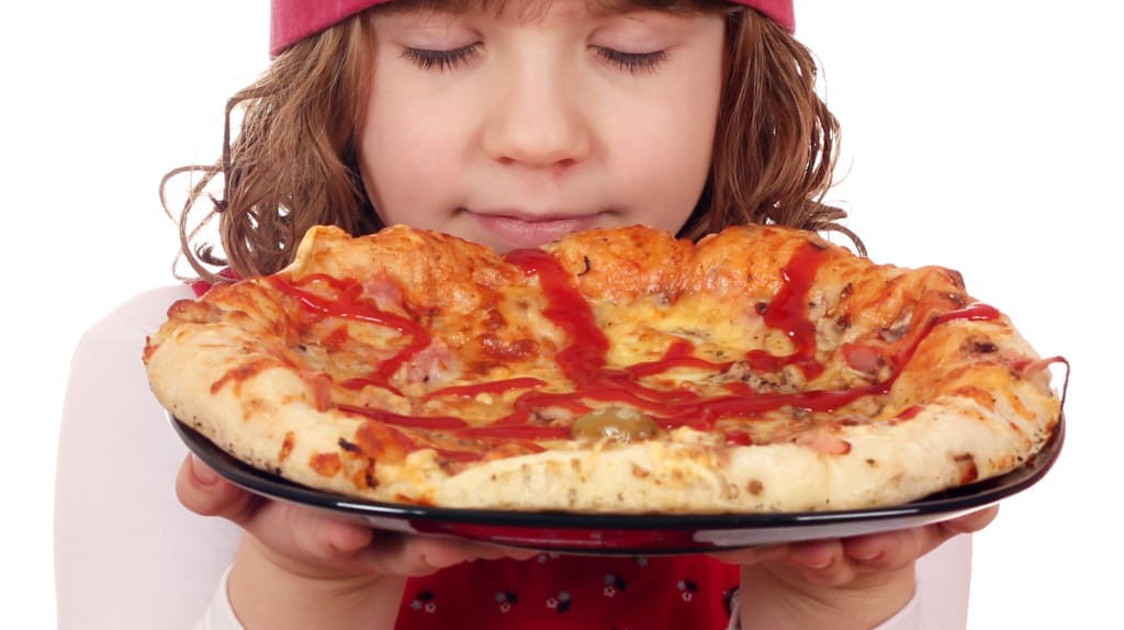 little girl cook smells pizza