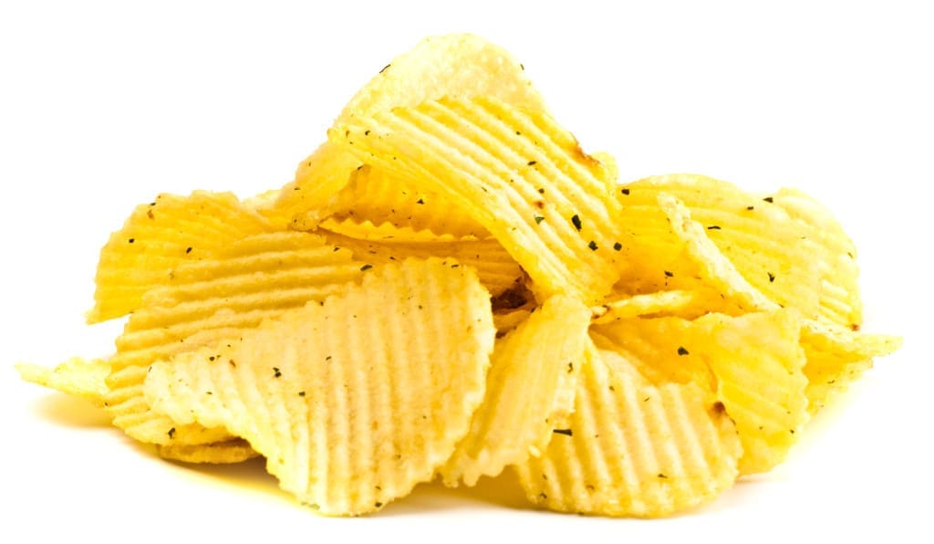 Handful of yellow potato chips isolated on white background