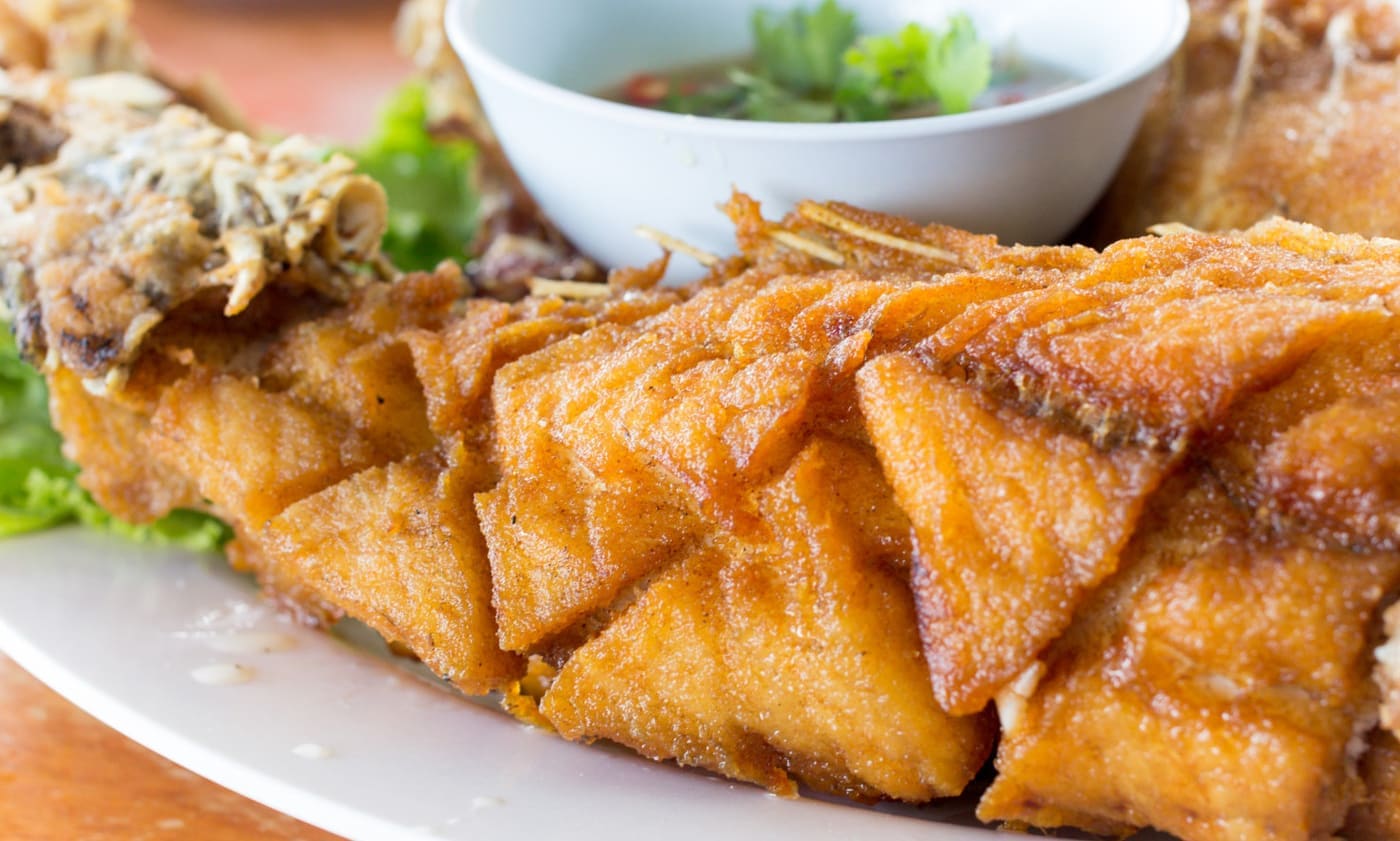score marks visible on fish - Fried seafish with Thai style sauce