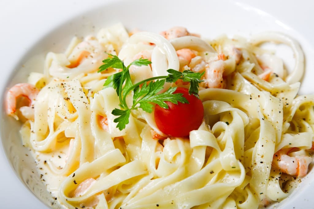pasta best cooked with boiling water - fresh pasta with seafood isolated on white