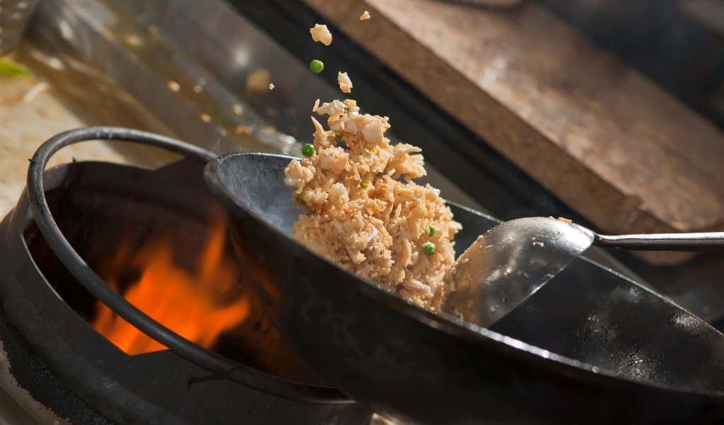 Closeup of fried rice being cooked in wok
