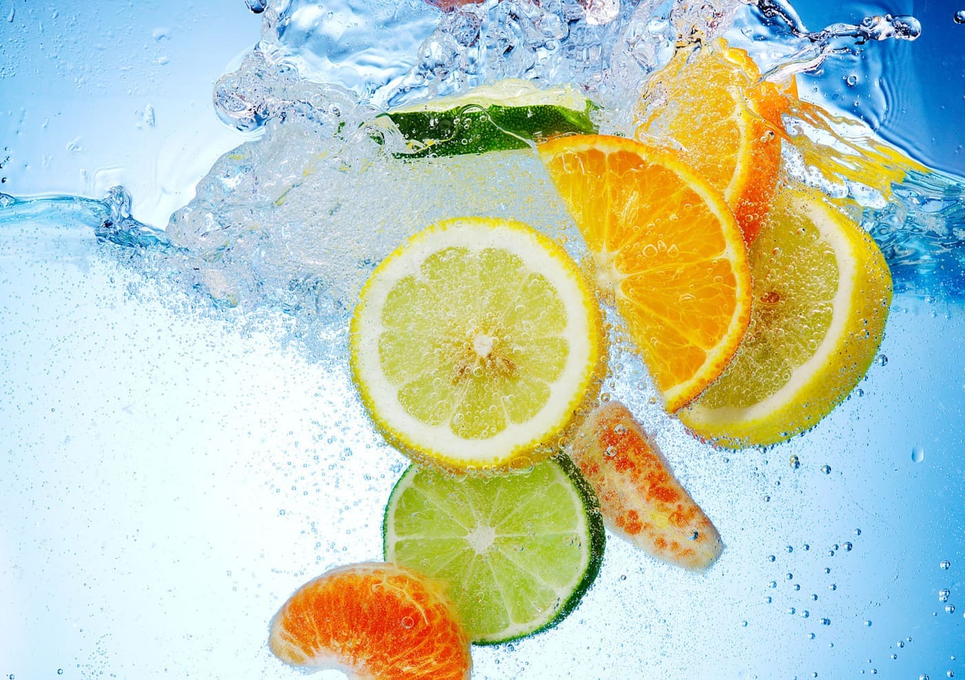 Citric acid citrus fruits - Tropical fruits are falling deeply under water with a big splash