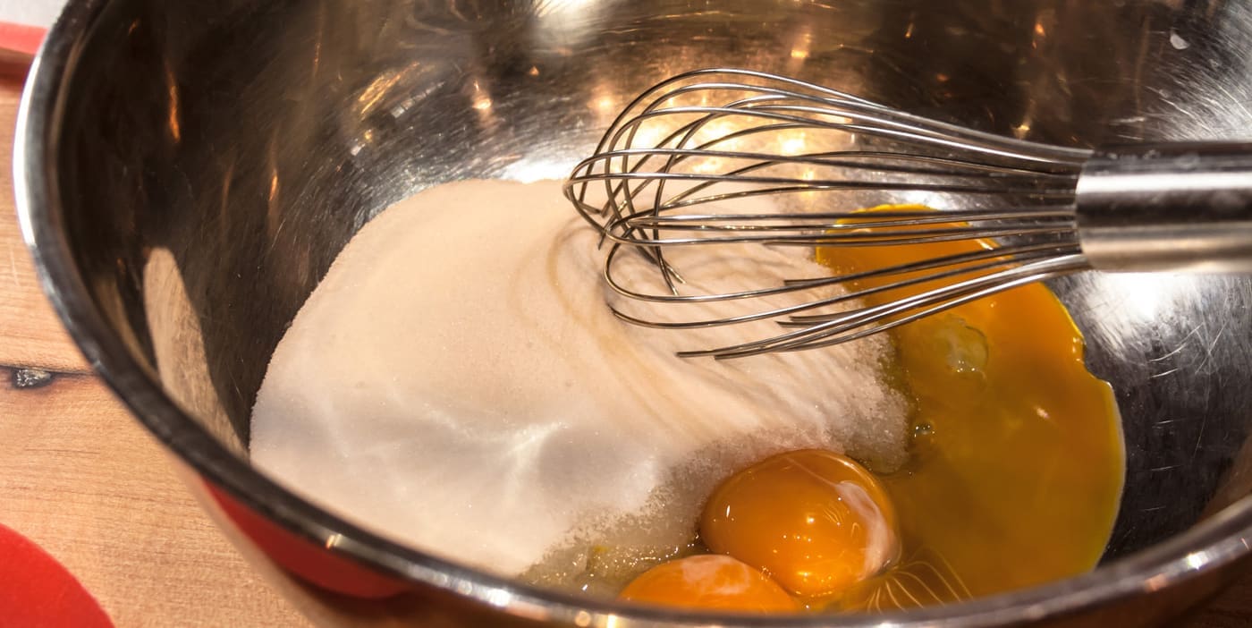 Eggs and sugar ingredients in silver bowl for base to make home made ice cream