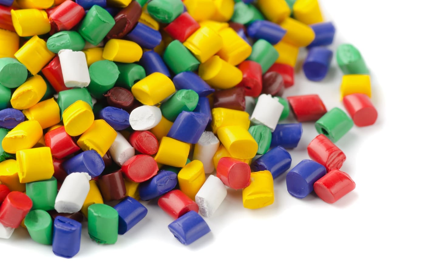plastic handlesssors made them light and colorful - on a pair of sciColourful plastic polymer granules on white