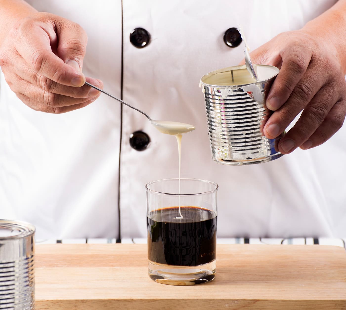 Chef putting sweetened condensed milk in to Hot coffee
